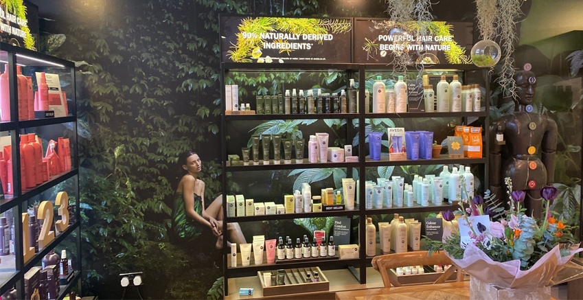A green storefront with wallpaper produced by QuickPrint