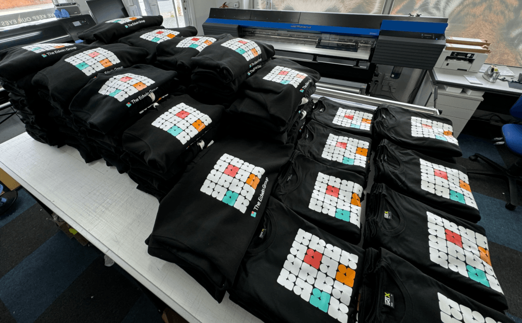 A large collection of branded hoodies for The Edwin Group, ready to be boxes and shipped.